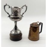 An Art Nouveau copper just with embossed floral pattern along with a trophy presented by Lyme