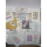 An assortment of loose leaves and stamps, lot also contains a selection of first day covers.