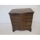 A mahogany serpentine fronted chest of four drawers with brush slide