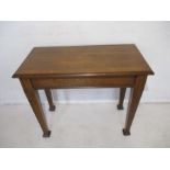 An oak side table on tapered legs, length 84cm, height 69cm.