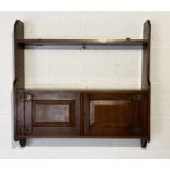 An oak hanging shelf with cupboard under