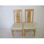 Two contemporary dining chairs.
