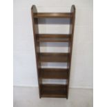 An oak freestanding bookcase with carved decoration, height 140cm.
