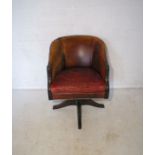 A vintage leather swivel office chair.