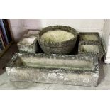 A quantity of various sized reconstituted stone garden pots and troughs, some named.