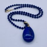 A 9ct gold mounted lapis lazuli pendant and chain