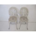 A pair of white painted bistro garden chairs, with Greek key Palmetto backs.