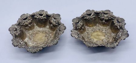 A pair of unmarked silver dishes with shell decoration