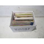 A quantity of 7" vinyl records, including The Beatles, Moody Blues, John Holt, Elvis Presley etc.