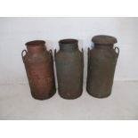 Three vintage milk churns, one with lid marked Unigate Creameries Ltd