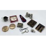 A collection of various items including vintage compacts, opera glasses, miniature ship in a
