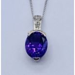 An amethyst coloured pendant set in unmarked white gold on a 9ct white gold fine chain