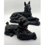 A large black plaster model of an Alsatian and another of a Poodle with signature to side