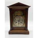 A turn of the century bracket clock with silvered dial