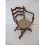 A Spanish style mahogany chair, with X frame stretchers.