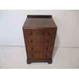 An Edwardian rosewood veneered small chest of four drawers, marked Maple & Co.