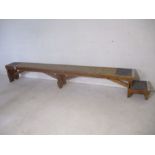An industrial wooden bench with step - from Axminster Carpets - Length 336cm, height 46cm, depth