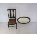 An Art Nouveau inlaid chair marked CK to base along with a carved mahogany oval wall mirror