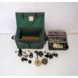 A quantity of fishing reels and tackle contained within two carry boxes, reels include Strike
