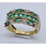 An emerald and diamond dress ring set in 9ct gold