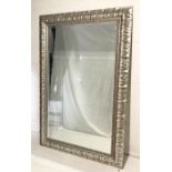 A large rectangular bevel edge wall mirror, in an ornate silvered frame, 178cm x 120cm.