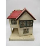 A vintage wooden dolls house - height 42cm