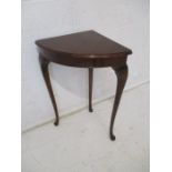 A mahogany corner table, on cabriole legs.