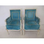 A pair of Julian Chichester designer arm chairs, with white painted frames and turquoise upholstery.