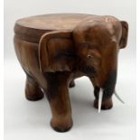 A carved wooden stool in the form of an elephant