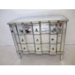 A mirrored chest of three drawers, length 103cm, height 89cm.