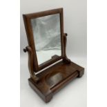 A Victorian mahogany toilet mirror with concealed drawer