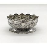 A hallmarked silver basket decorated with swags, shaped rim and repousse work, London 1884, weight