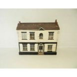 A vintage dolls house, including some dolls and furniture.