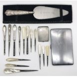 A hallmarked silver match book holder, silver handled cake slice, silver handled sewing items etc.