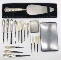 A hallmarked silver match book holder, silver handled cake slice, silver handled sewing items etc.