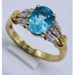A 9ct gold dress ring with diamond set shoulders