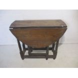 An antique oak dropleaf table with single drawer, one leaf as found.