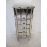 A tall narrow mirrored chest of six drawers, length 48cm, height 115cm.