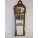 An ornate gilt framed wall mirror, height 145cm.