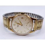 A 1960s 9ct gold Rolex Precision, signed champagne dial, baton hour markers, and numerals at 9,