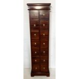 A tall chest of fourteen drawers 153cm x 42cm x 23cm