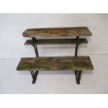 A cast iron framed garden bench, with weathered wooden seating and adjustable top.