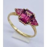 A 9ct gold three stone ring set with pink tourmaline