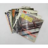 A collection of Beatles 12" vinyl record albums, including 'Please Please Me', 'Help', 'With The
