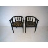 A pair of antique ebonised tub chairs on tapering legs, A/F.