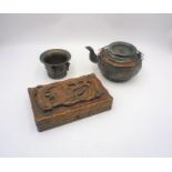 An Oriental clay tea pot with dragon motif and character mark to base, along with a carved wooden