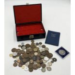 A collection of various coinage in a coin display box