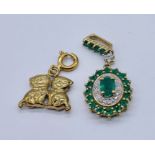 A 9ct gold emerald and diamond pendant along with a 9ct gold charm of cats