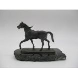 A bronze figure of a horse, on a marble plinth.