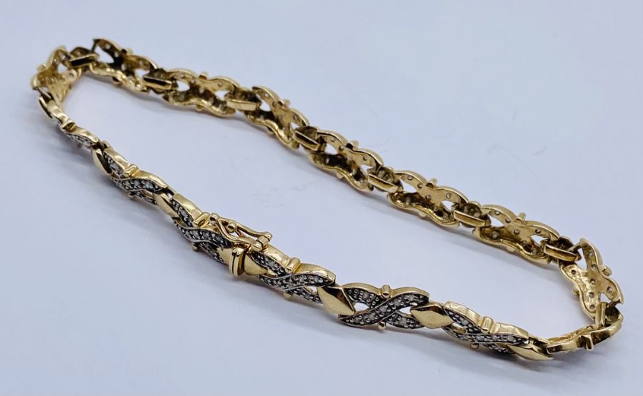 A 9ct gold bracelet set with diamonds, total weight 9.7g